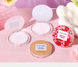 Detailed view of open and closed floral solid perfume balm compacts on pink background