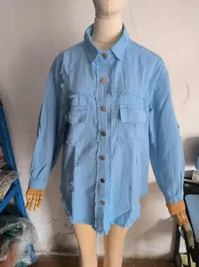 Women's loose light blue distressed denim jacket with frayed edges and ripped details
