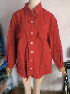 Close-up of a red ripped denim jacket with silver buttons and distressed raw hem on a mannequin