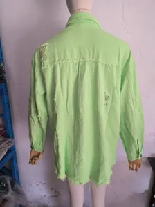 Back view showing ripped details of oversized lime green distressed denim jacket for women