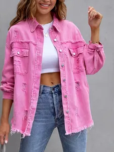 Detailed shot of pink distressed denim jacket featuring frayed edges and ripped texture