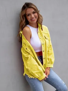 Close-up of yellow ripped denim jacket with distressed hem detailing