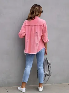Back view of a pink oversized distressed denim jacket with frayed hem and ripped details