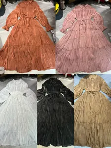 Detailed view of elegant pleated tiered maxi dresses in multiple silk-like colors