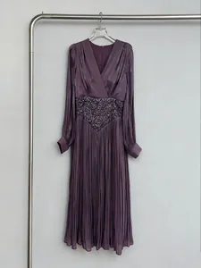 Elegant purple V-neck pleated maxi dress with intricate floral embroidered waist detail