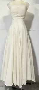 Elegant white pleated sweetheart neckline maxi dress with a flowing skirt for spring 2026.
