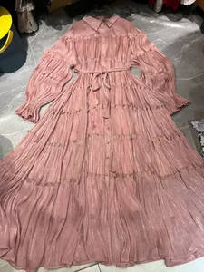 Detailed view of dusty pink pleated tiered maxi dress with button-up collar and waist tie