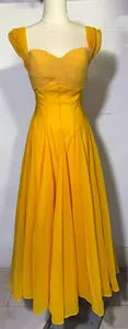 Close-up of yellow pleated maxi dress with elegant sweetheart neckline design
