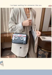 Lifestyle view of a creative cassette tape-shaped crossbody bag with gold chain strap