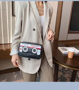 Close-up detail of the creative cassette tape design on a black PU crossbody bag