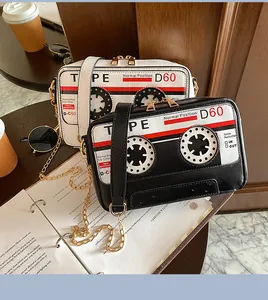 Retro cassette tape style PU crossbody bag with elegant gold chain strap details.