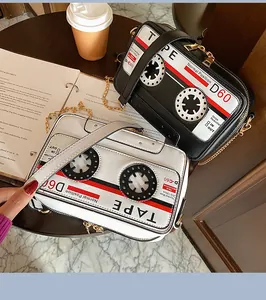 Detailed macro view of retro cassette tape shaped PU crossbody bags in black and white colors