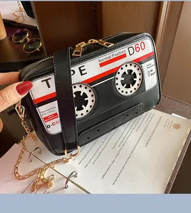 Detailed view of the retro cassette tape shaped PU leather crossbody bag with metal chain strap.
