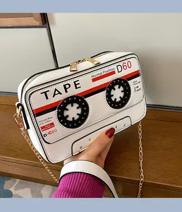 Detail showing unique cassette tape design on a white crossbody bag