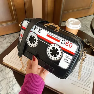 Detailed macro view of a creative retro cassette tape shaped PU crossbody bag with gold chain