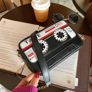 Close-up of a stylish creative cassette tape shaped crossbody bag with a metal chain