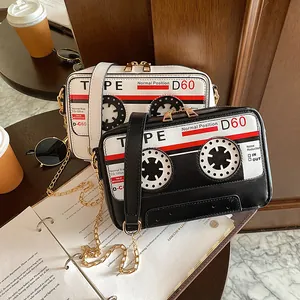 Retro cassette tape design PU crossbody bags in black and white with chain straps.