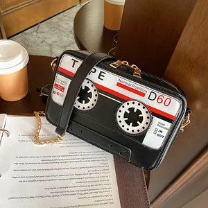 Close-up detail of a creative vintage cassette tape shaped black crossbody bag