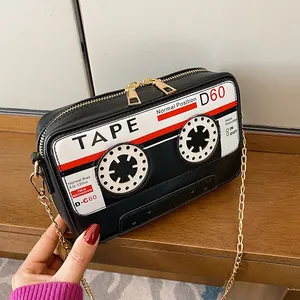 Detailed view of vintage cassette tape design on black PU leather crossbody bag with chain