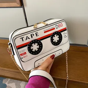 Vintage retro cassette tape shaped white PU leather crossbody bag with gold chain.