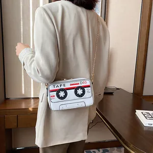 Trendy retro cassette tape design PU leather crossbody bag with elegant gold chain strap.