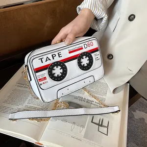 Close-up of retro cassette tape shaped PU crossbody bag with golden chain strap