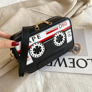 Retro cassette tape shaped crossbody bag made of PU leather with gold chain strap detail