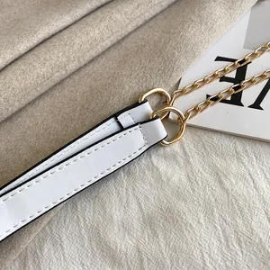 Close-up detail of a white PU leather shoulder strap and gold chain for a crossbody bag