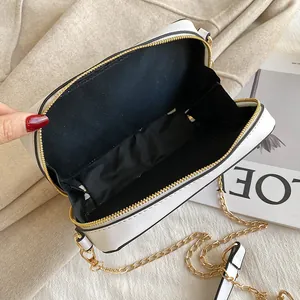 Interior view of white cassette tape crossbody bag with black lining and gold zipper