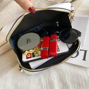 Close-up view of the spacious interior of a cassette tape shaped bag filled with accessories.