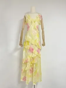 Elegant floral print maxi dress featuring irregular ruffles and V-neckline on mannequin