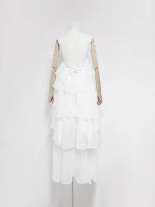 Detailed back view of an elegant white tiered ruffle maxi dress with criss-cross lace-up