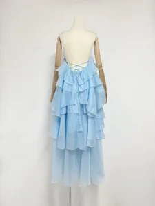 Detailed back view of a light blue French ruffled tiered maxi dress with lace-up straps.