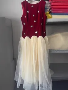 Elegant burgundy velvet sleeveless dress with sequin flowers and cream tulle skirt