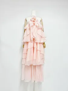 Detailed view of an elegant pink tiered ruffle long dress featuring a 3D floral neck