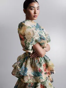 Close-up detail of this elegant retro floral tiered puff sleeve dress with a high waist