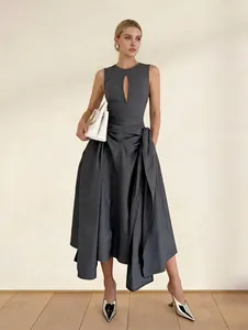 Detail view of grey sleeveless dress with cutout front and pleated asymmetrical hem