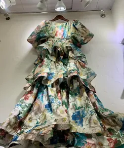 Detailed view of the layered ruffles and floral print of a vintage puff sleeve dress.