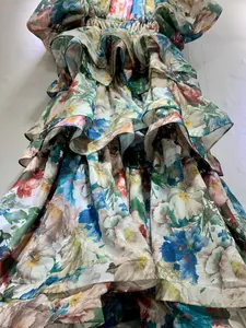 Detail view of vintage French style floral tiered cake dress with elegant puff sleeves