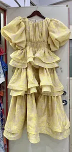 Vintage pale yellow tiered maxi dress featuring puff sleeves and an elegant floral print