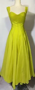 Close-up detail of the chartreuse pleated dress with sweetheart neckline on mannequin