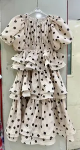 Elegant retro cream polka dot tiered cake dress with puff sleeves and high waist.