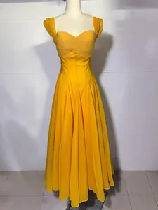 Elegant yellow sweetheart neck pleated dress with flowy maxi skirt for formal occasions.