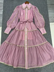 Detailed view of a pink French court style lace-up dress with lantern sleeves and lace