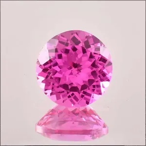 Macro view of a brilliant round-cut lab-grown pink sapphire with sharp facets