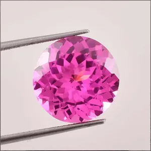 Macro view of brilliant round lab-grown pink sapphire with fine facets