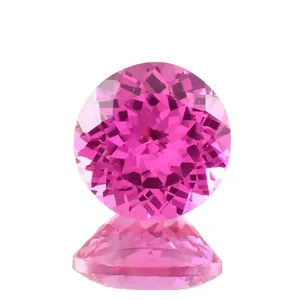 Vibrant lab-grown pink sapphire round brilliant cut gemstone on white background