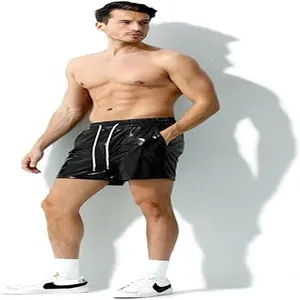 Model wearing shiny black leather shorts with white drawstring for casual style