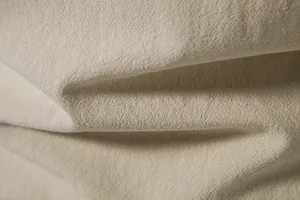 Macro view showing the breathable cotton linen fabric texture of the men's beach shirt.
