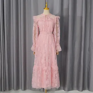 Detailed view of an elegant pink vintage lace maxi dress featuring lantern sleeves and a waist belt